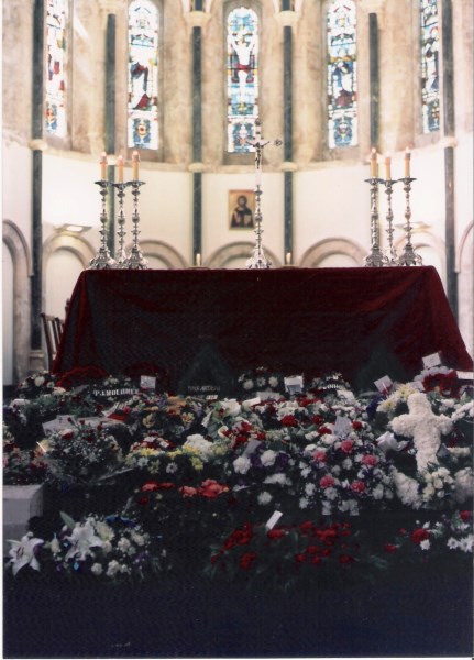 Floral tributes in front of the altar at St. Nicolas' Church following the Service of Remembrance